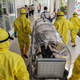 Indonesian health officials conduct an exercise drill in transporting a patient requiring isolation at the Belawan port in Medan on February 3, 2020.